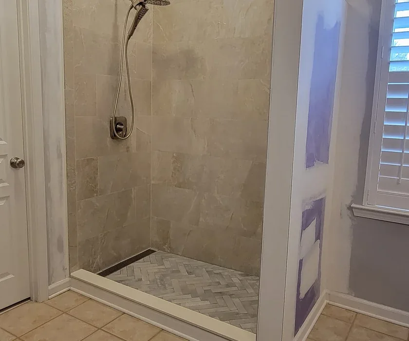 Remodeled bathroom with tiled walk-in shower and glass enclosure in a Charlotte, NC home