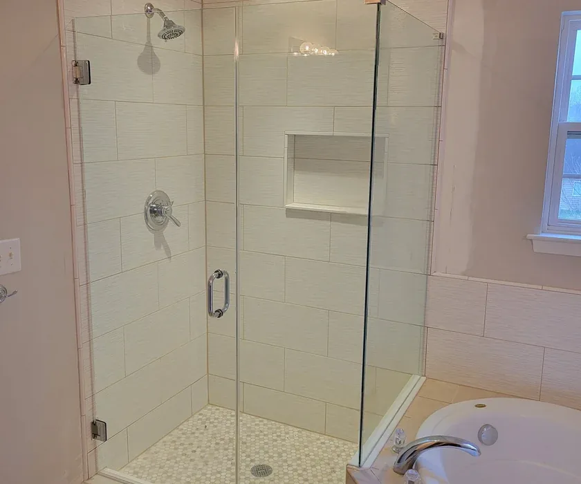 Remodeled bathroom with tiled walk-in shower and glass enclosure in a Charlotte, NC home