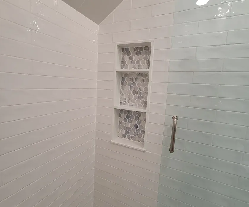 Remodeled bathroom with tiled walk-in shower and glass enclosure in a Charlotte, NC home