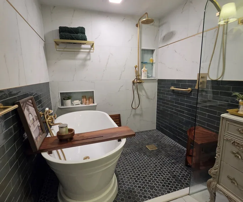 Ceramic shower tile and custom glass enclosure detail from a bathroom renovation