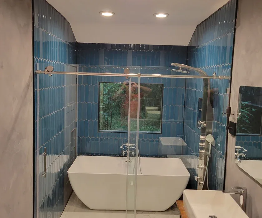 Remodeled bathroom with tiled walk-in shower and glass enclosure in a Charlotte, NC home