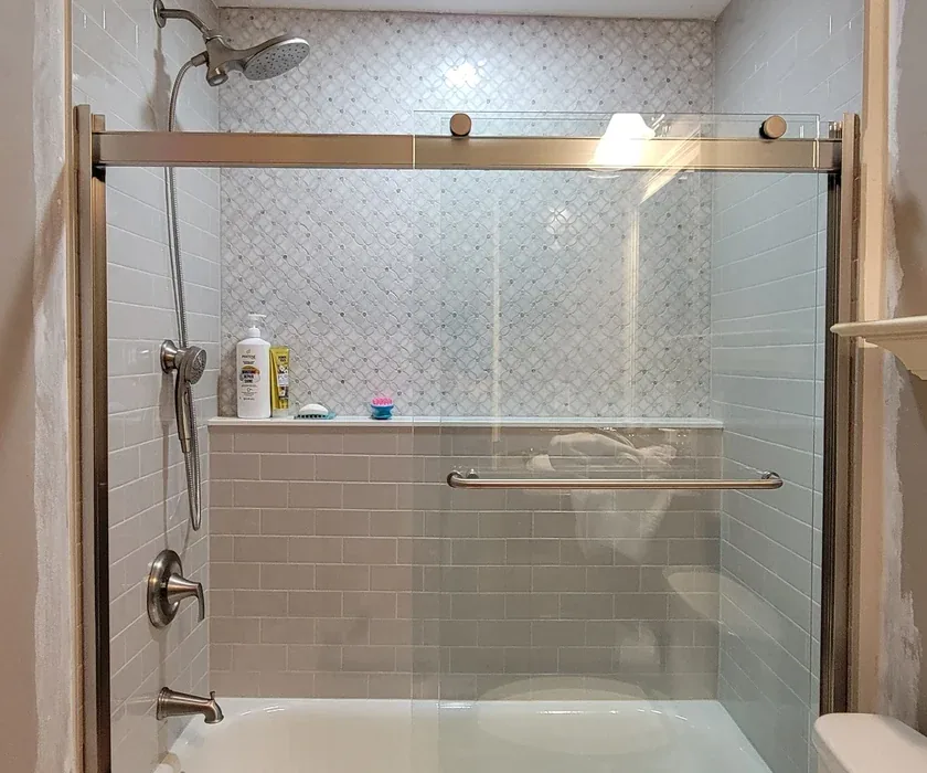 Remodeled bathroom with tiled walk-in shower and glass enclosure in a Charlotte, NC home